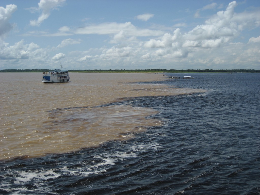 The black waters of Rio negro meet the murky waters of Rio Solimoes.
