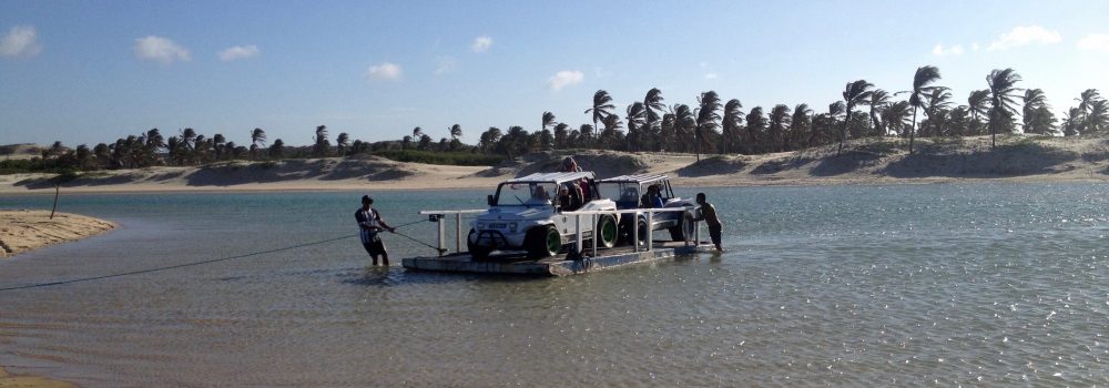 A buggy is taken accross a lagoon in Guajiru by ferry. 
