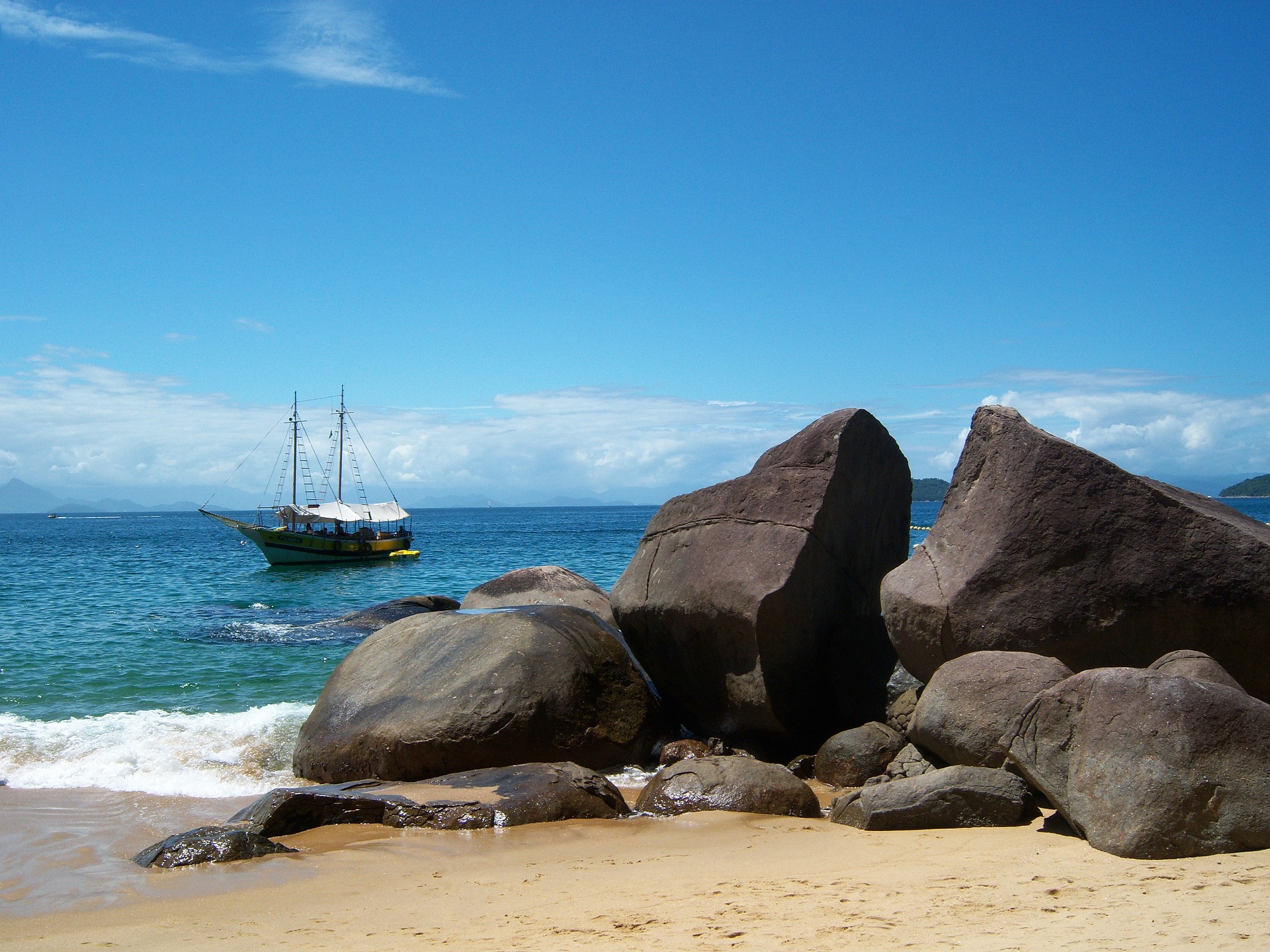 Ilha Grande shore, huge boulders and a sailboat.