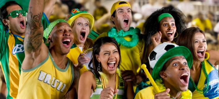A group of Brazilian football supporters cheer on their team.