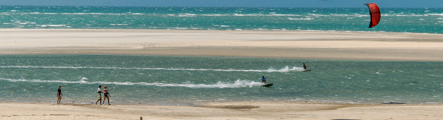 Panoramic shot of two kitesurfers riding a lagoon in Ilha do guajiru.