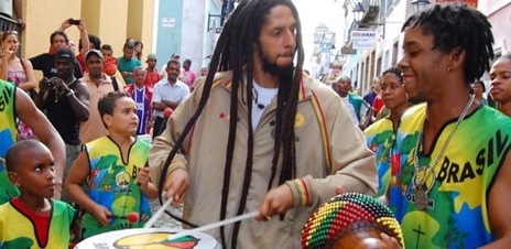 Member of Olodum plays drum with crowd in Brazil.